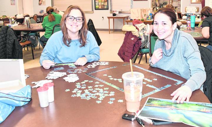 <b>Kristen Umansky of Wantage and Christine Wieladek of Vernon look up from heir puzzles.</b>