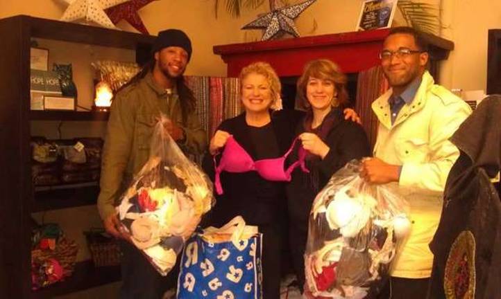 Michele VanAllen and Dawn Gomez of Garden of Life Massage &amp; Yoga Center are shown with representatives from the mission accepting the collection last year.