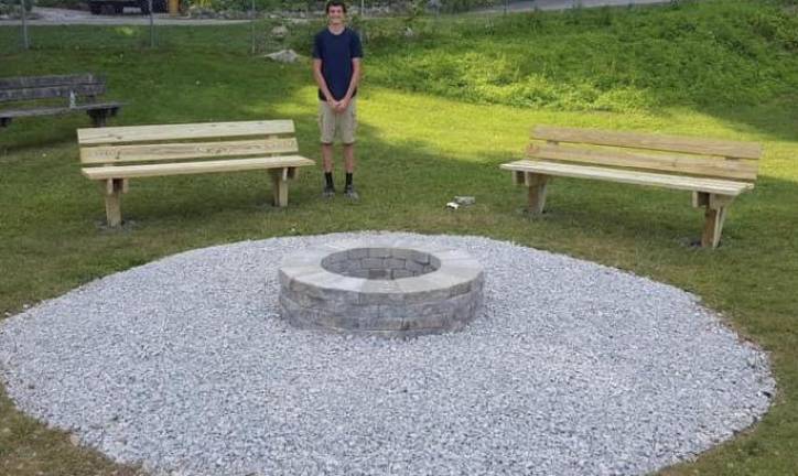 Vernon Township Eagle Scout Jonathan Chromcik is shown with his Eagle Scout project, a fire pit and benches.