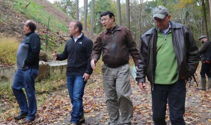 Congressman Josh Gottheimer (NJ-5) assesses the waste pile alongside Vernon Mayor Harry Shortway (left). In the background, rebar, cement, asphalt, and rusted piping can be seen mixed in among the waste.