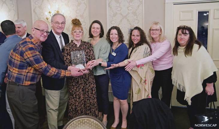 From left are Sussex Borough Councilman Mario Poggi, Sussex Borough Mayor Ed Meyer, Dianna Morrison of Norwescap, Jenn Salt of Zufall Health, Heather Thompson of Norwescap, Valerie Macchio of Sparta Community Food Pantry, Lisa Weber of Norwescap and Laura Mickley of Norwescap with the Business Innovation Award from the Sussex County Chamber of Commerce. (Photo provided)