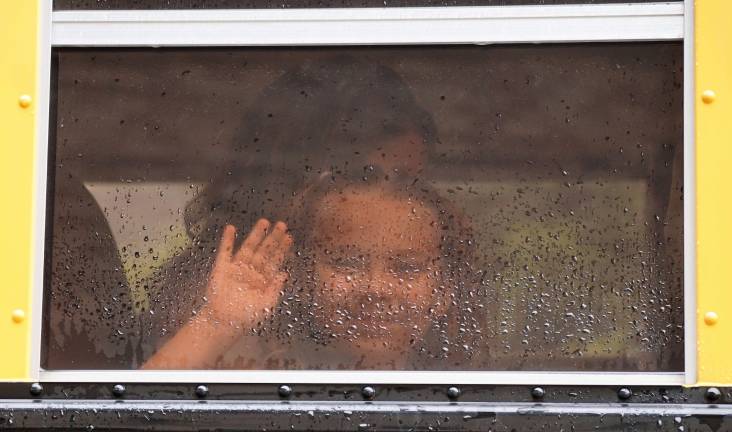 A little face peeks out through the rain.