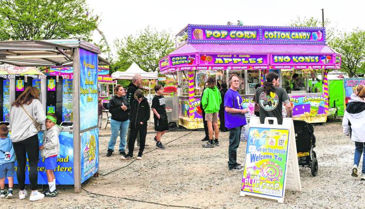 <b>Visitors walk the midway at the Memorial Day Carnival at Skylands Stadium.</b>