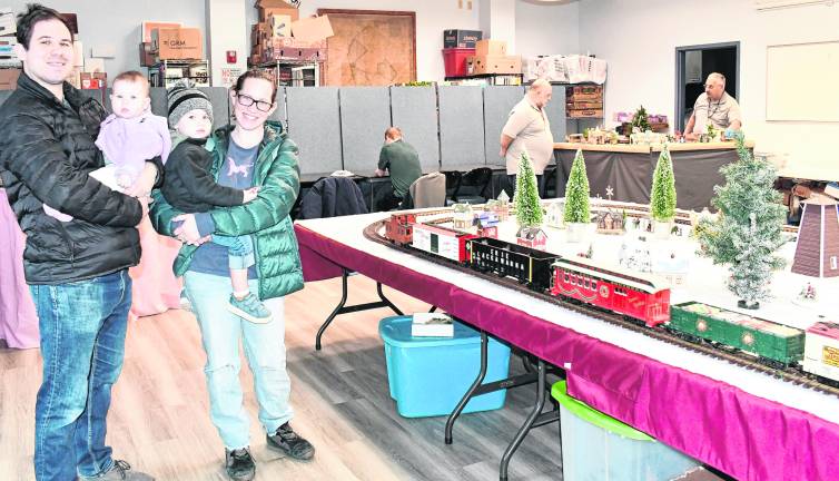 <b>Cameron, Elizabeth, Cohen amd Megan Lukas from Newton pose by a rain display.</b>