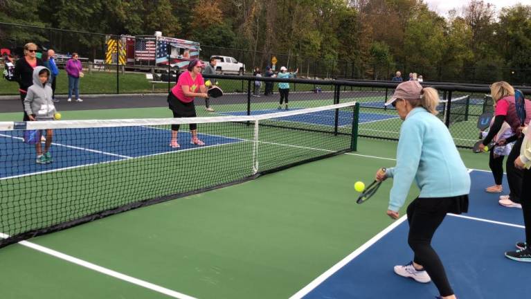 Members of the Dinkerbells pickleball team of Ogdensburg show new players the game.