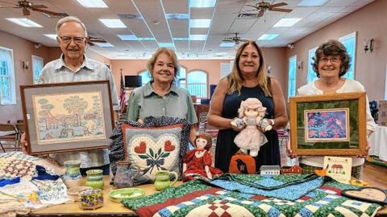 <b>From left, Richard and Barbara Gardiner, Chris Delnero and Barbara Morgan with items for the 78th annual Lord’s Auction on Saturday, Aug. 30. (Photo provided)</b>