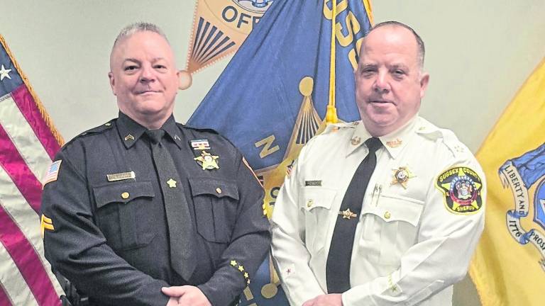 <b>Sussx County Sheriff Michael Strada, right, stands with retiring Cpl. Jason Kimble.</b>