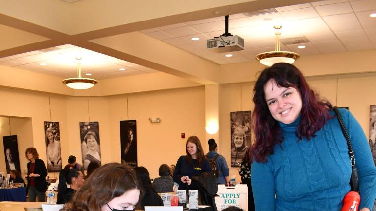 <b>Lupin Furey looks at a book while Julia Ferreira of Hamburg looks on.</b>