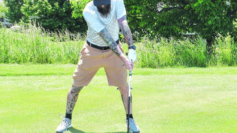 <b>Tim O'Neill of Sussex golfs.</b>