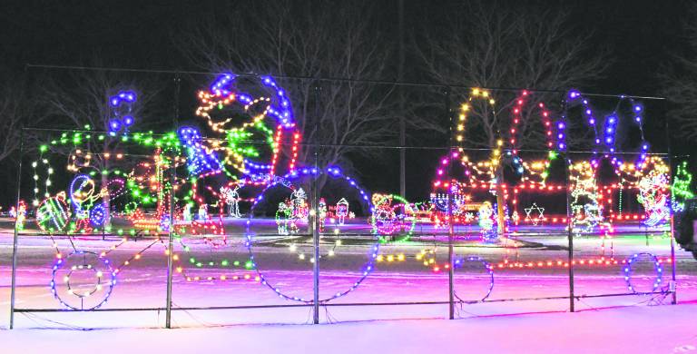 <b>A display of an elf pulling wagon with lights is shown.</b>