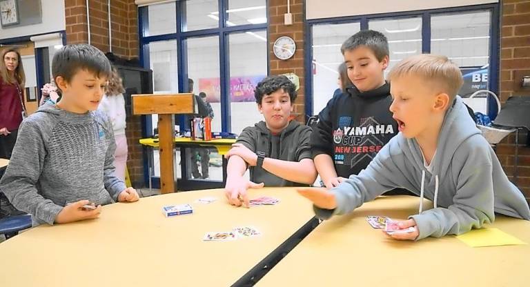 Students play the War card game.