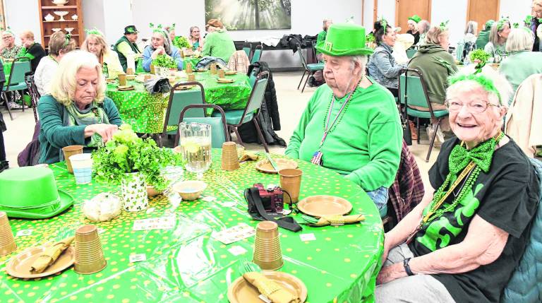 <b>Susanne Austin of Vernon, William Remes of Vernon and Terri Vanemburgh of Highland Lakes prepare for their St. Patrick's Day meal.</b>