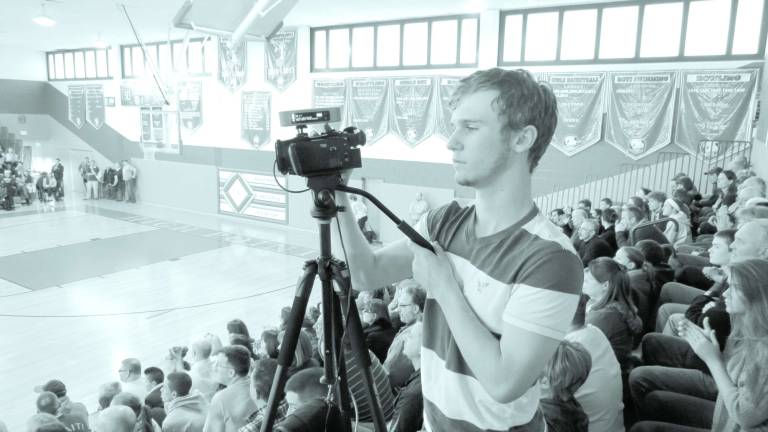 Media Technology student Garrett Fenlon shoots video of a recent High Point girls basketball championship game. It was the first event the school streamed live over the Internet.