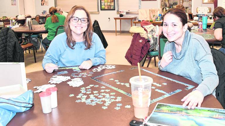 <b>Kristen Umansky of Wantage and Christine Wieladek of Vernon look up from heir puzzles.</b>