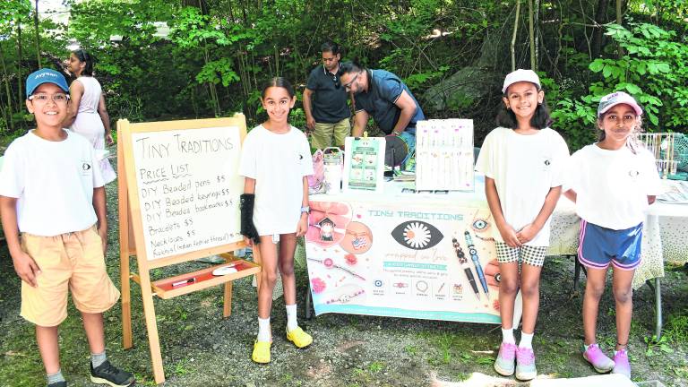 <b>Avyaan Varshney, Myrah Gulati, Sisira Moragudi and Anya Dhebaria, all of Bellemead stand in front of their story, Tiny Traditions.</b>