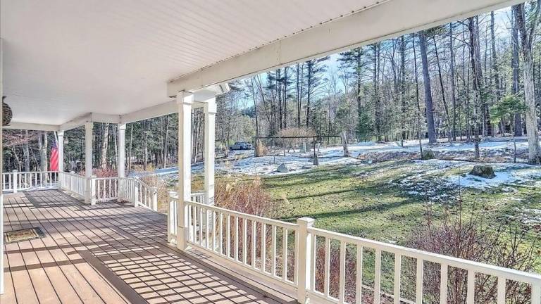 Upscale streamfront custom farmhouse offers space and more
