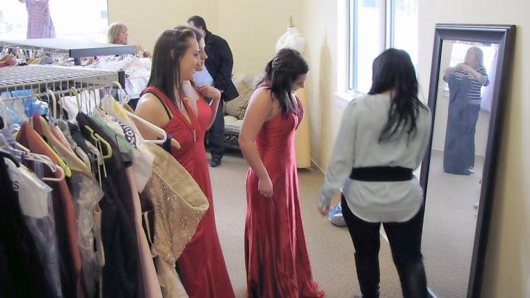 Teen girls try on prom dresses at Sister to Sister Prom Shop (Photo provided)