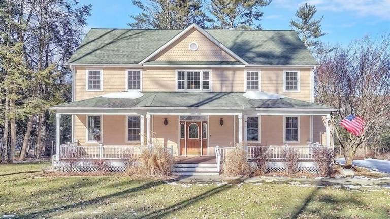Upscale streamfront custom farmhouse offers space and more