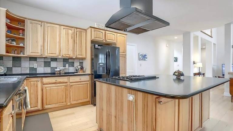 Upscale streamfront custom farmhouse offers space and more
