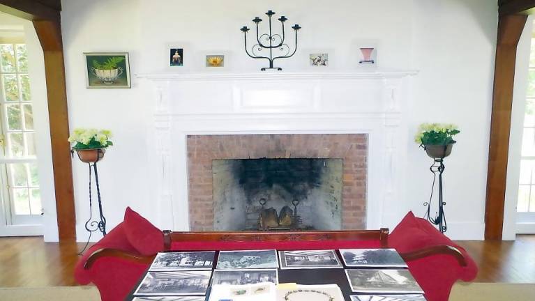 The living room in the main house, with a collection of old photographs showing how the residence used to look. (Photo by George Leroy Hunter)