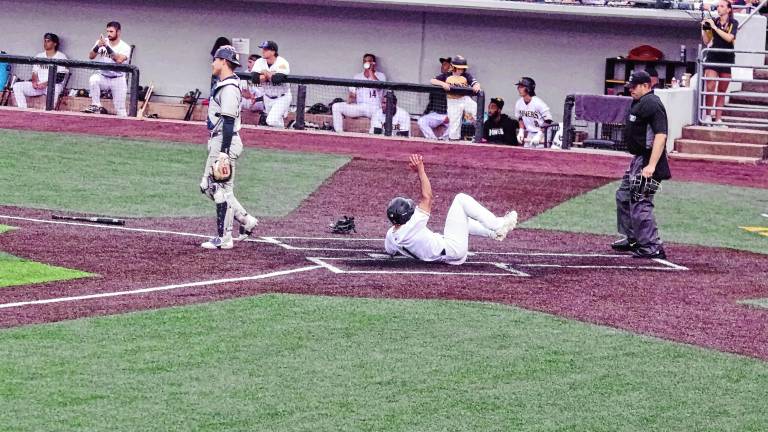 <b>In the fifth inning of the Sussex County Miners’ game against the Québec Capitales on June 13, Dom Johnson of the Miners slides safe across home plate to increase his team’s lead to 3-0. The Miners won, 6-0. (Photos by George Leroy Hunter)</b>