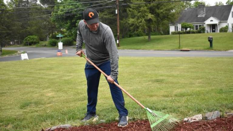 PIA1 Matt Hamann of Sparta spreads mulch at Katie’s House in Stillwater. (Photos by Laurie Gordon)