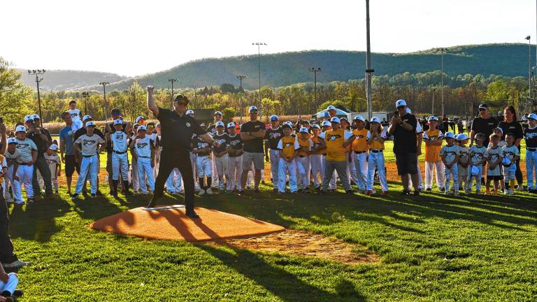 <b>Mayor Anthony Rossi throws the first pitch on the Vernon Little League’s opening night Friday, May 2 at Veterans Memorial Park. The field has a new lighting system. (Photos by Maria Kovic)</b>