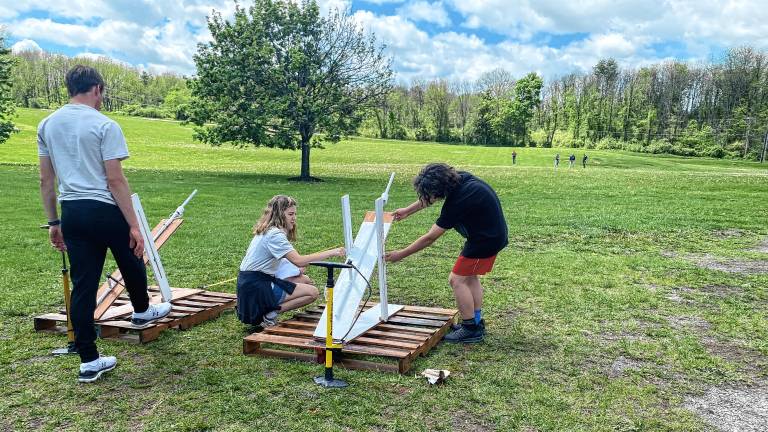 Hardyston Middle School competitors and high school assistants, from left, Noah DeRenzo, Emily Guarino and Jovanni Portilla prepare their launcher for final testing during the annual STEM League Challenge on May 7. (Photos by Juleanna Green)