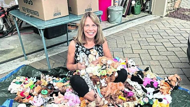<b>Vernon Township Woman’s Club member Lisa Mills sits among the collection of cuddly Beanie Babies the club recently donated to Operation Smile for children undergoing cleft palate surgery.</b>