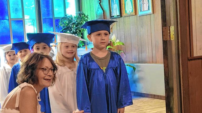 Hunter Rios, 5, is the next Our Savior Nursery School graduate to walk into the ceremony June 6. (Photos by Theresa Esposito)