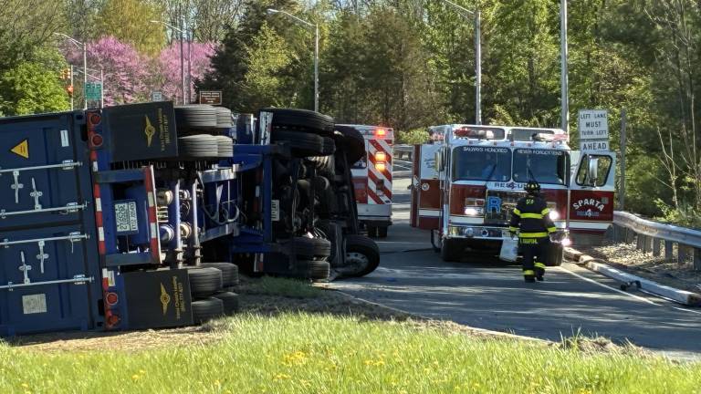 A dump truck is on its side on the northbound off-ramp of Route 15 leading onto Route 517 in Sparta on Wednesday morning, April 30. (Photo by Jeanne Straus)