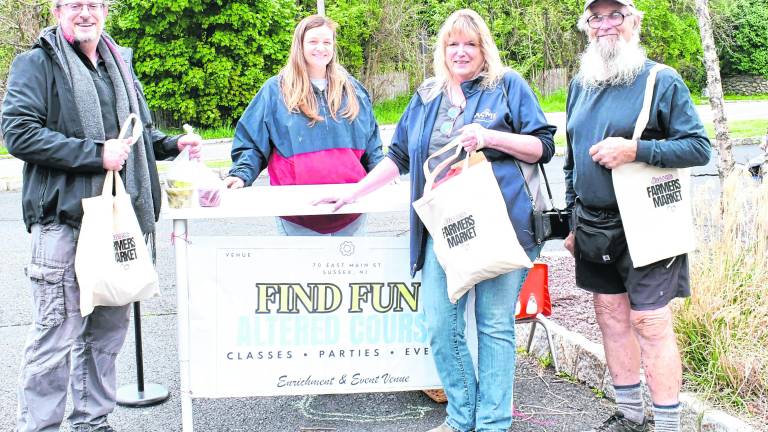 <b>Karl Hafner of Sussex, Liz Rockwell of the Altered Course Store, Kathy Drost of Sussex and Artie Grimes of Franklin pose with Sussex Market shopping bags.</b>