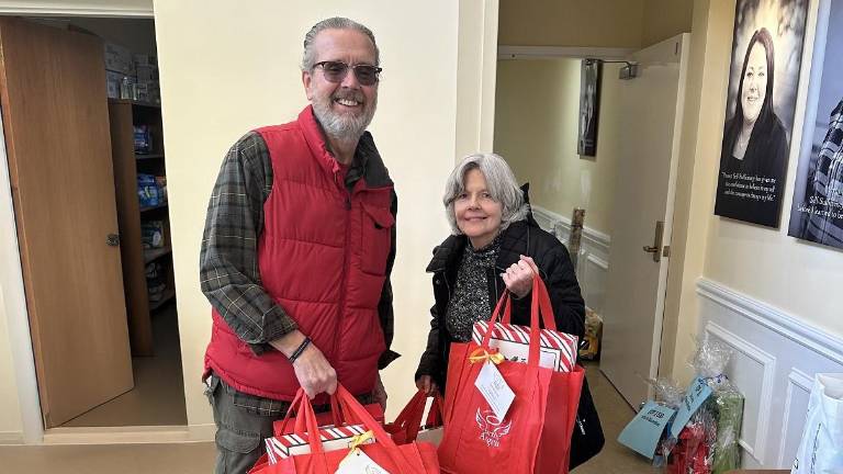<b>Alice and Kevin Prendergast assemble gift bags for local senior citizens as part of Project Self-Sufficiency’s Earth Angels initiative.</b>