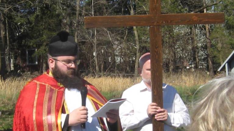 Fr. Chris Barkenhausen, pastor of St. Francis de Sales Church in Vernon and church congregation begin outdoor Stations of the Cross on Good Friday.