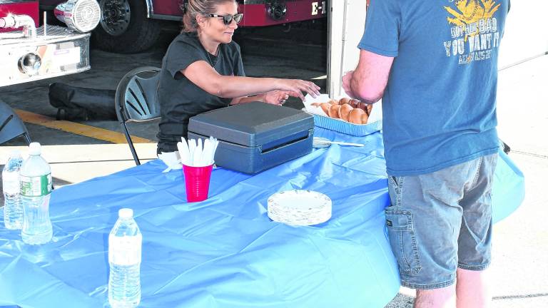 <b>Mike Smith of Vernon is served his food.</b>