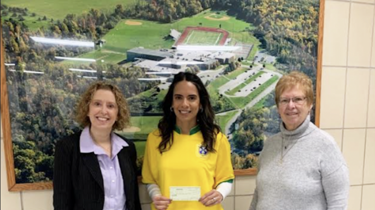 Vernon Township High School Principal Lindsay LeDuc, center, holds a check presented to the high school by Vernon Township Historical Society trustee Nancy Adams, right. At left is school board president Kelly Mitchell. (Photo provided)