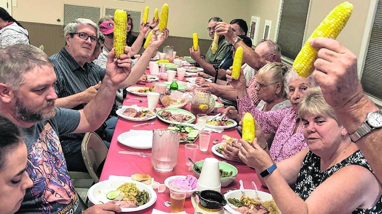 <b>Diners toast corn on the cob.</b>