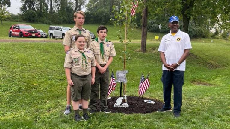 Boy Scout Troop 283 members, from left, Rhys Moore, John Verdonik and Adam Miraglia stand with Mayor Howard Burrell next to the 9/11 Survivor Tree seedling.