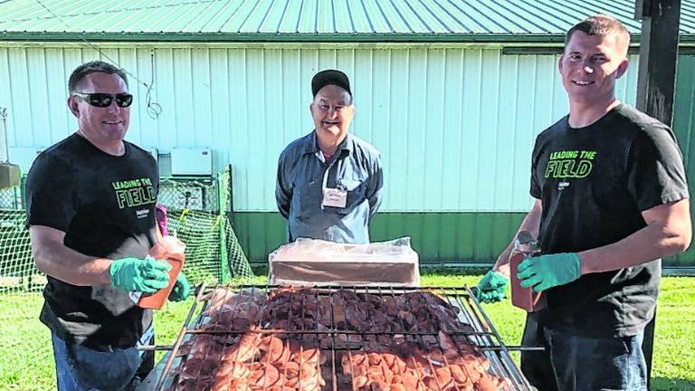 <b>Art Fetzer and sons help prepare the barbecue.</b>