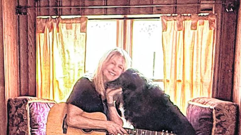 <b>Deb D’Anne and her rescue Scooter in her Middleville studio</b>