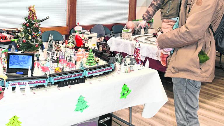 <b>Coyote and his father, Mike, Moeller of Lake Hopatcong look at a train display.</b>
