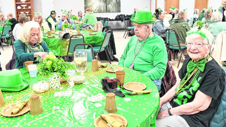 <b>Susanne Austin of Vernon, William Remes of Vernon and Terri Vanemburgh of Highland Lakes prepare for their St. Patrick's Day meal.</b>