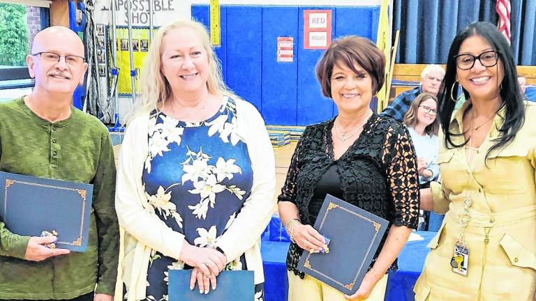 <b>Vernon Township Superintendent Eveny de Mendez, right, stands with the district’s 25-year employees.</b>
