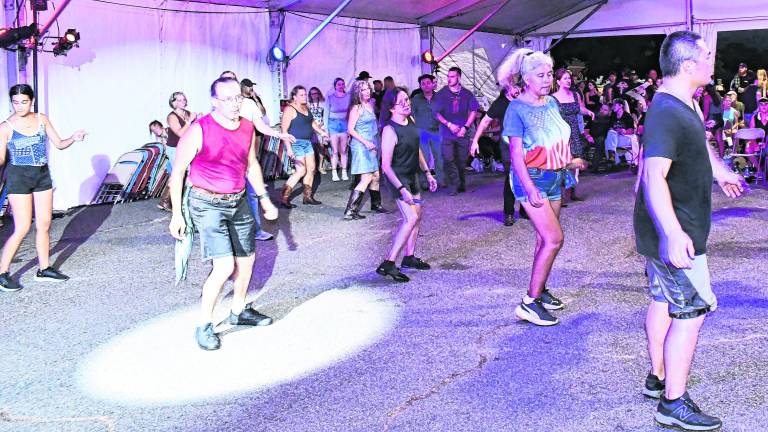 <b>Dancers participate in the line dancing competition.</b>